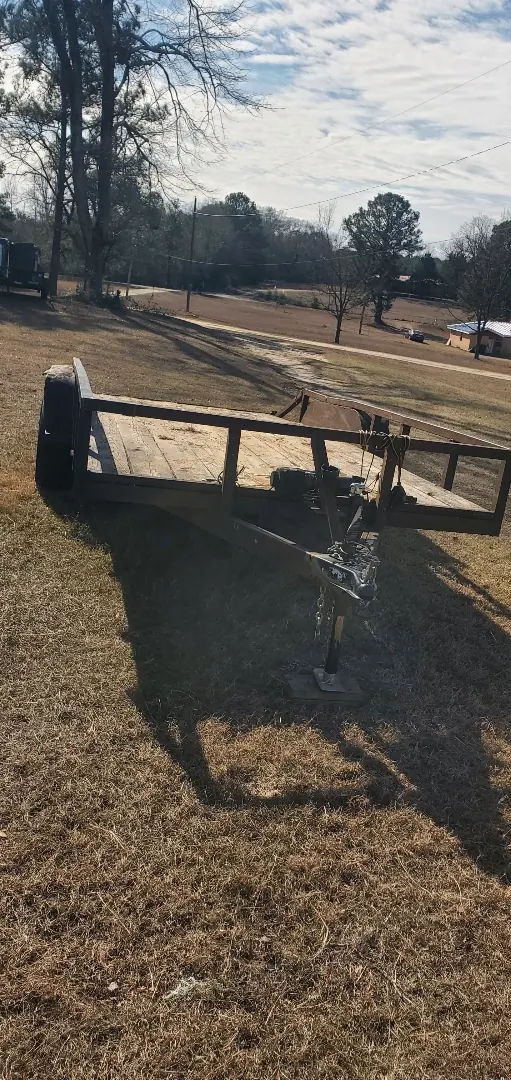 Equipment shadow across a cleared outdoor work area